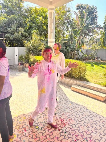 Guests celebrating Holi festival with colors in Rajasthan