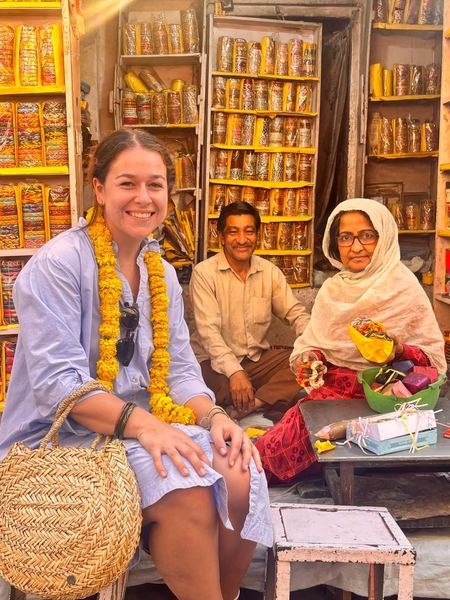 Guest with local artisans at a colorful bangle market in Jaipur