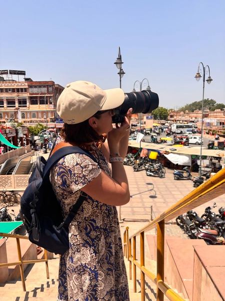 Guest photographing the bustling bazaar street in Jaipur