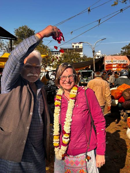 Guest receiving a traditional marigold garland welcome in Rajasthan