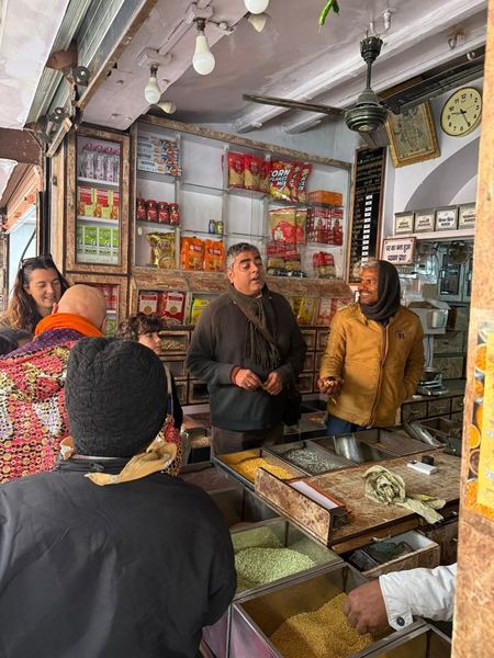 Guests visiting a traditional spice shop on a Rajasthan market tour