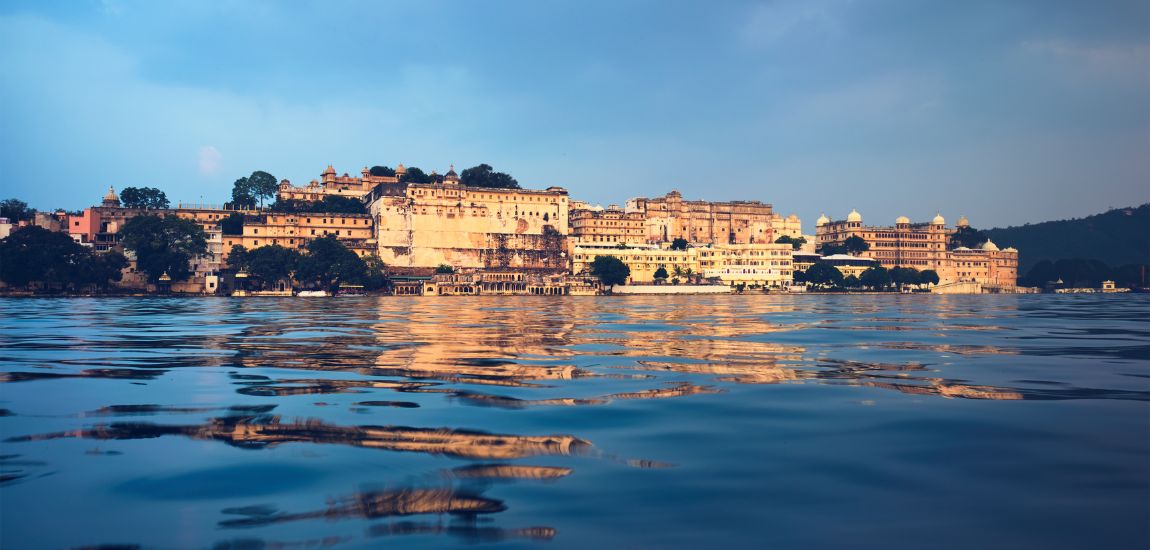 International tourists enjoying Lake Pichola in Udaipur Rajasthan